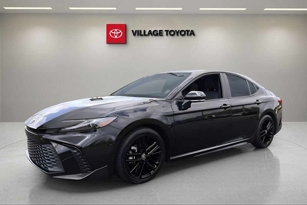 2025 Toyota Camry LE in Black — front three-quarter view
